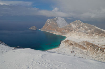 Scenic view of sea and mountains against sky