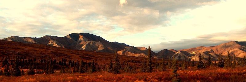 Scenic view of mountains against cloudy sky