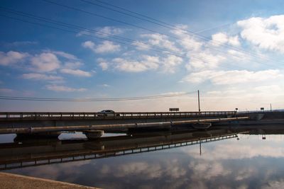 Bridge over city against sky