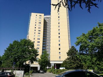 Low angle view of buildings against clear blue sky