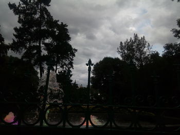 Silhouette of trees against cloudy sky