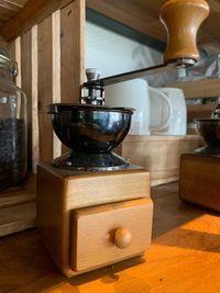 Close-up of coffee grinder on table at home