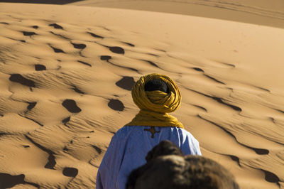 Rear view of woman with umbrella on beach