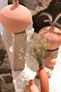 Earthenware vases and objects, pastel terracotta colors, with still life like vegetation