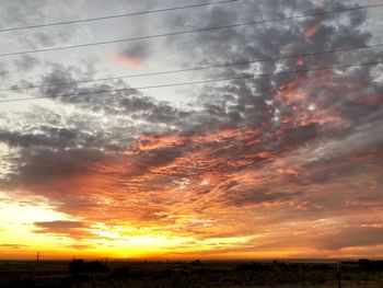 Low angle view of sky over silhouette landscape during sunset