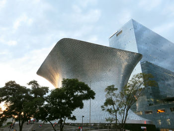 Low angle view of building against cloudy sky