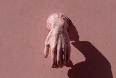 Close-up of angel statue against wall