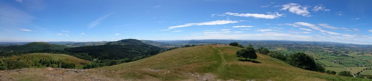 Panoramic view of landscape against blue sky