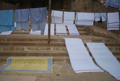 Indian textiles drying on the steps next to ganges river