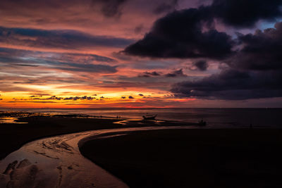 Scenic view of beach against sky during sunset