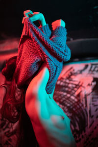 Close-up of woman hand on red fabric