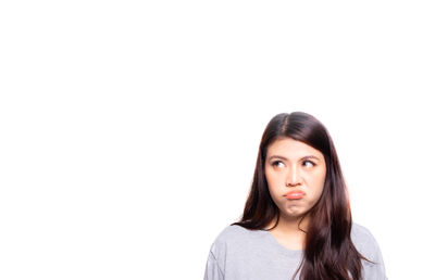 Portrait of a beautiful young woman against white background