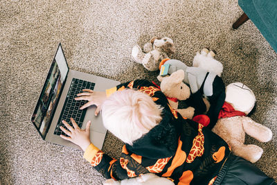 Young boy video conferencing with class on computer