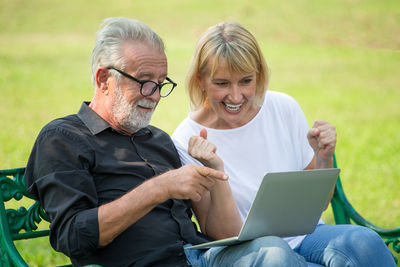 Man and woman sitting on mobile phone
