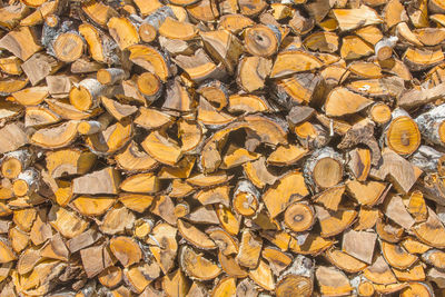 Chopped and stacked pile of pine and birch wood. texture, background