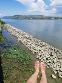 Low section of woman by lake