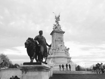 Low angle view of statue against cloudy sky