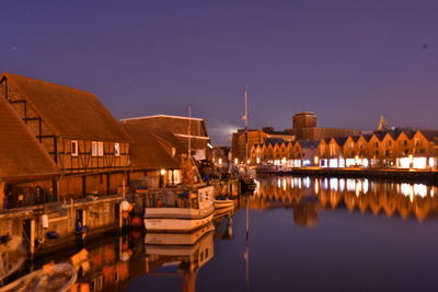 Reflection of buildings in river at night