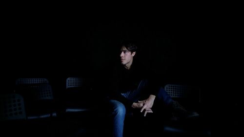 Two people sitting in darkroom