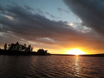 Scenic view of lake against sky during sunset