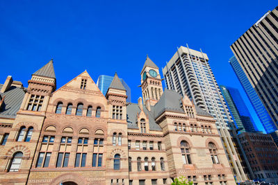 Low angle view of buildings against blue sky