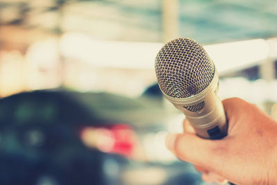 Close-up of hand holding microphone