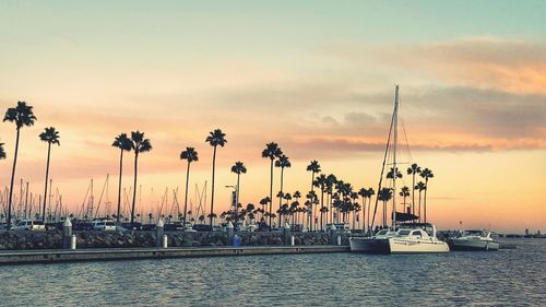 View of boats in calm sea at sunset