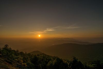 Scenic view of silhouette mountains against sky at sunset