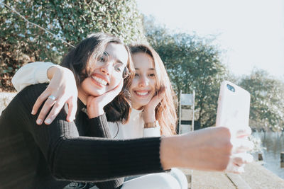 Young female friends taking selfie outdoors