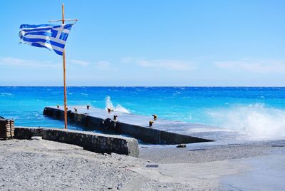 Scenic view of beach against blue sky