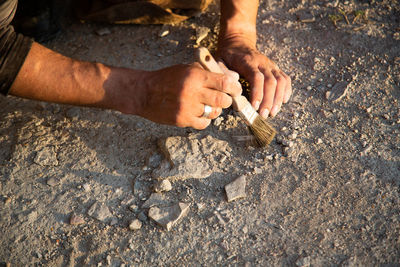 Low section of man standing on rock