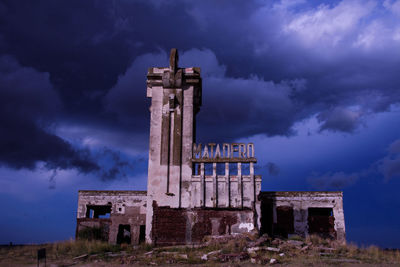 Old ruin building against sky at dusk