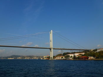 Suspension bridge over bosporus against blue sky