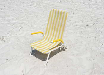 High angle view of yellow pepper on sand at beach