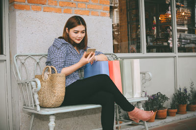Young woman smiling while sitting in basket