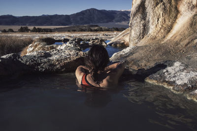 Rear view of woman relaxing in bridgeport hot springs