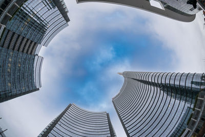 Low angle view of buildings against cloudy sky