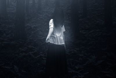 Woman standing in forest