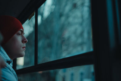 Portrait of man looking through window