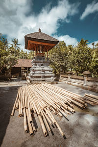 Built structure against trees and building against sky