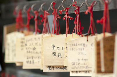 Close-up of text hanging on wood