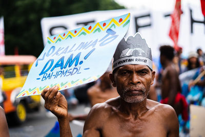 Portrait of shirtless man with text