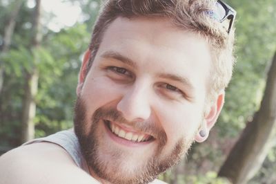 Close-up portrait of smiling young man