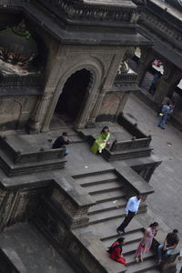 High angle view of people walking on staircase of building