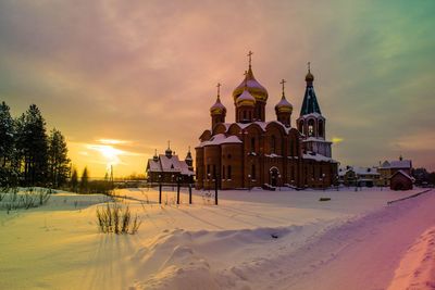 Church against cloudy sky during winter