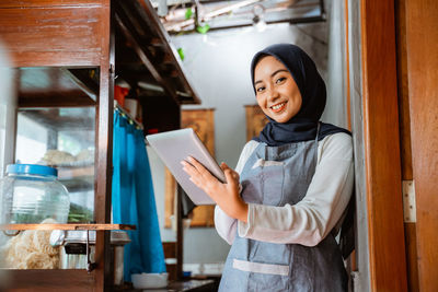 Portrait of young woman using mobile phone