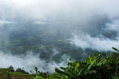 Scenic view of waterfall against sky