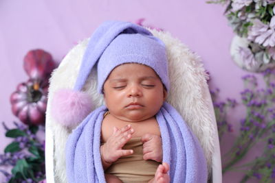 New born baby in lavender colour cap