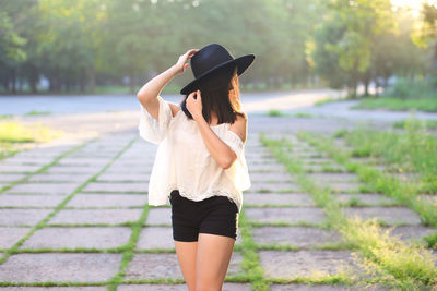 Woman wearing hat standing outdoors