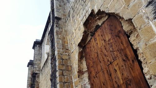 Low angle view of old ruin building against sky
